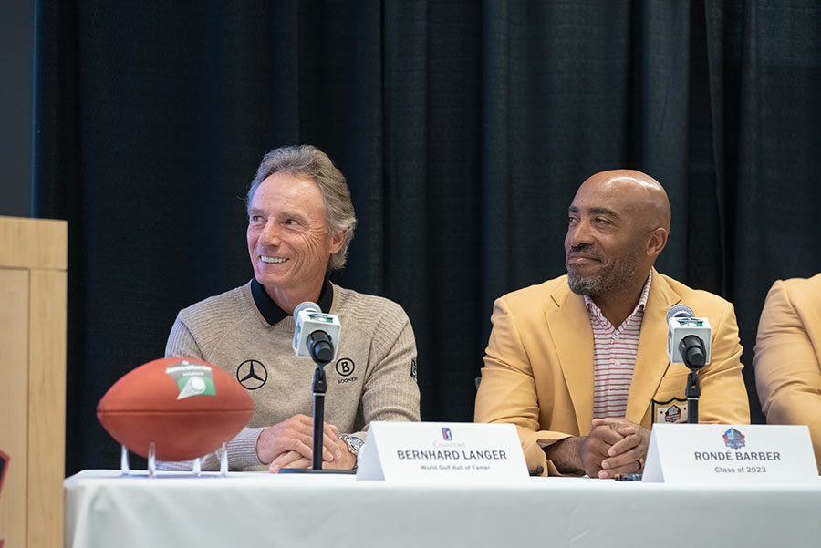 langer and barber sitting at a table during press conference