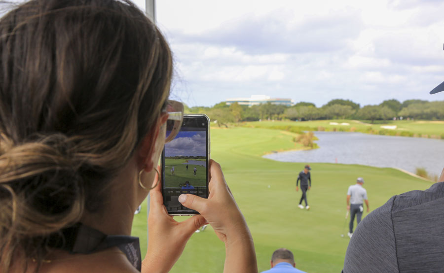 girl taking photo of golfer