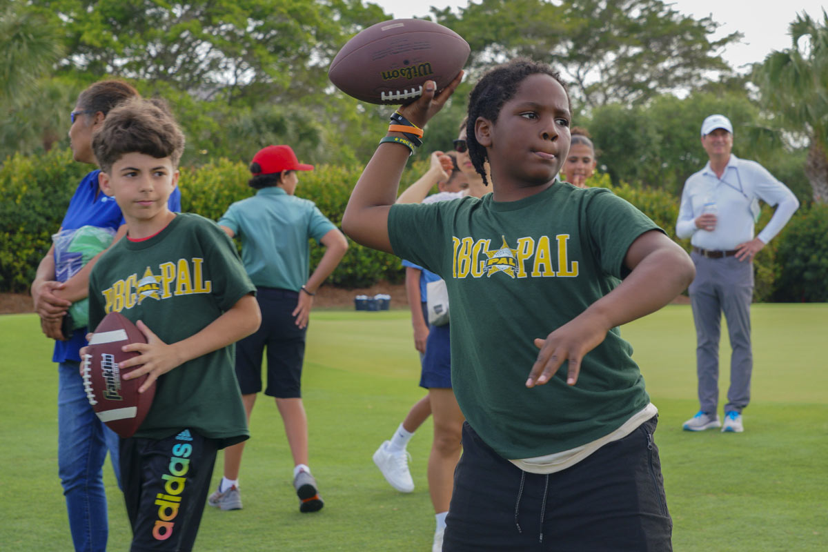 girl throwing football
